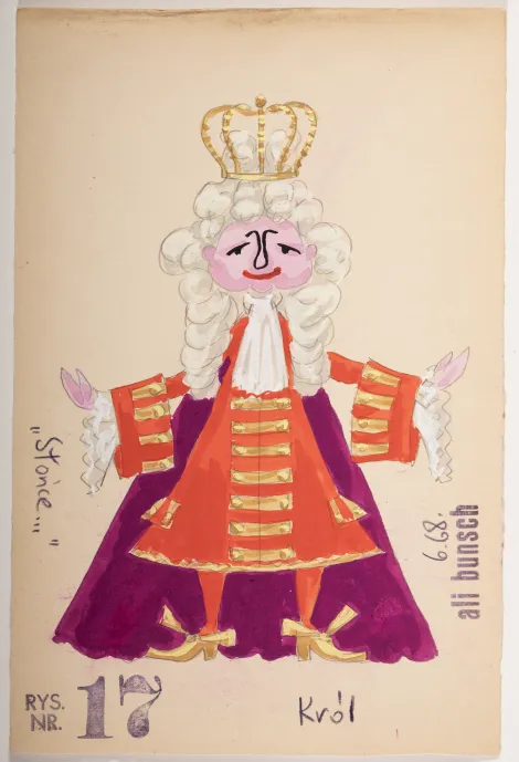 Król - Mężczyzna w długich włosach, z koroną na głowie, ubrany na czerwono ze złotymi zdobieniami i fioletową pelerynę.